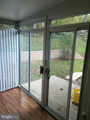 a view of a room with wooden floor and door