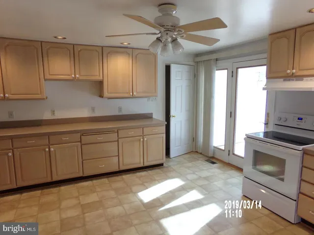 a view of a kitchen with electric appliances