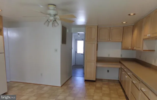 a view of a hallway to a bedroom and chandelier