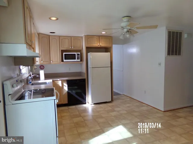 a kitchen with refrigerator and cabinets