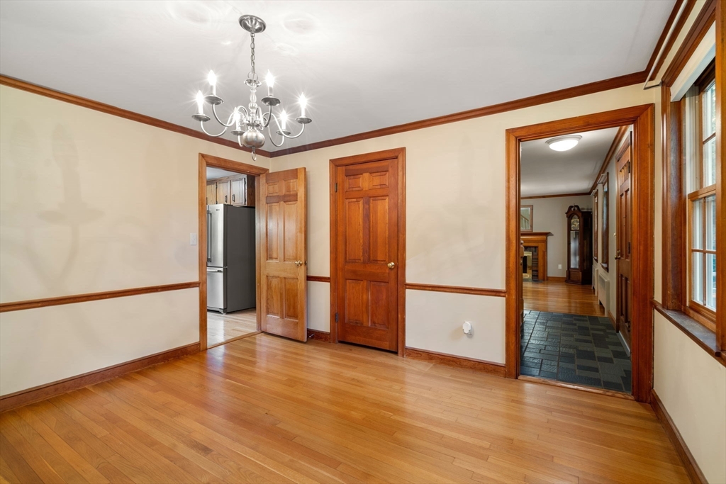 12 Glover Road Wayland, MA 01778 - Photo 14 of 27 a view of a hallway with wooden floor and a chandelier