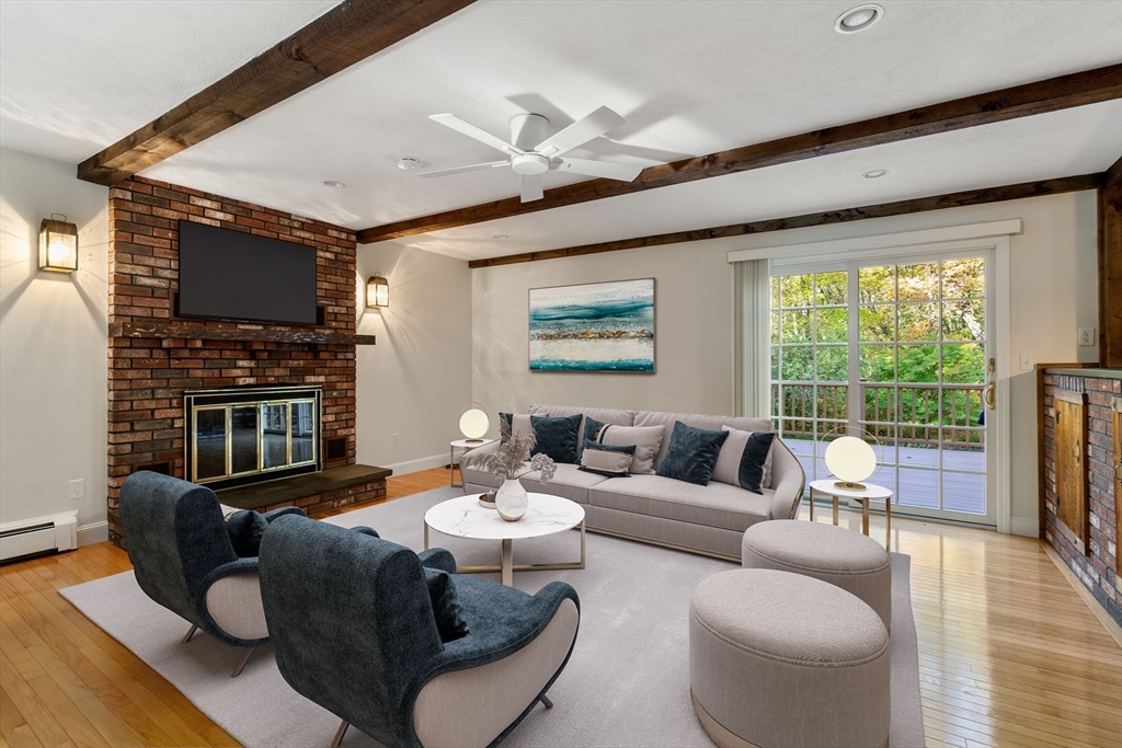 12 Glover Road Wayland, MA 01778 - Photo 3 of 27 a living room with fireplace furniture and a flat screen tv
