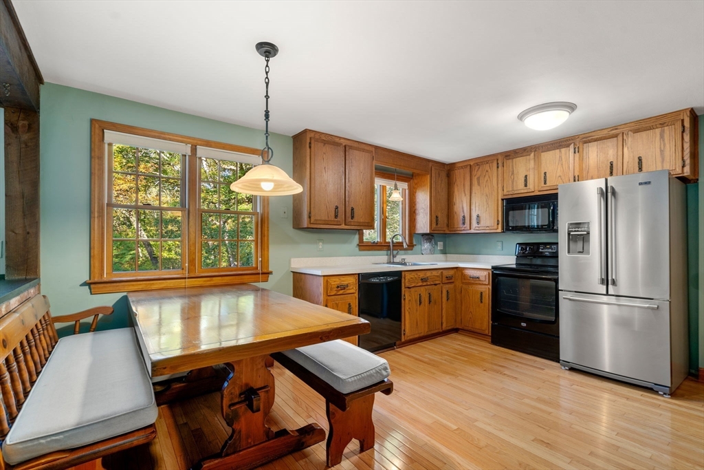 12 Glover Road Wayland, MA 01778 - Photo 8 of 27 a kitchen with refrigerator cabinets dining table and chairs