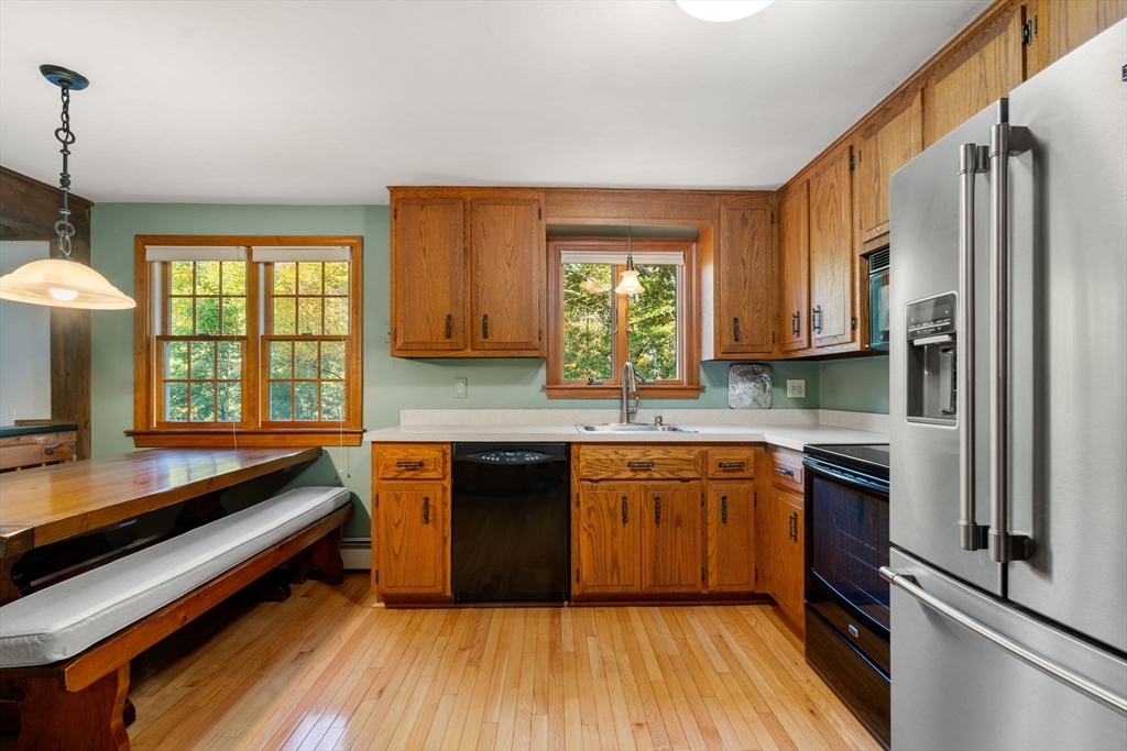12 Glover Road Wayland, MA 01778 - Photo 9 of 27 a kitchen with stainless steel appliances granite countertop a stove a sink and a refrigerator