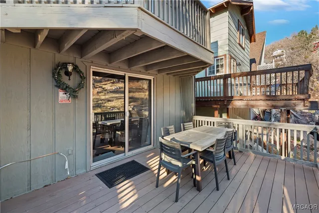 a view of a deck with table and chairs and wooden floor