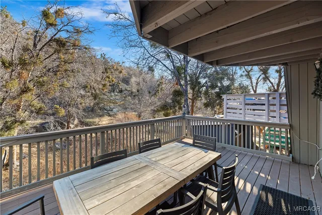 a view of a wooden chairs on the roof deck