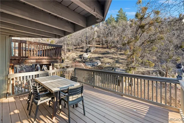 a view of a chairs and table on the deck