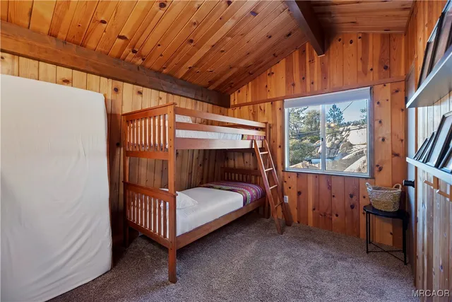 a bedroom with furniture and a large window