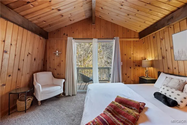 a bedroom with furniture and a large window