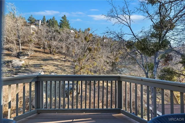a view of a roof deck with wooden floor and fence
