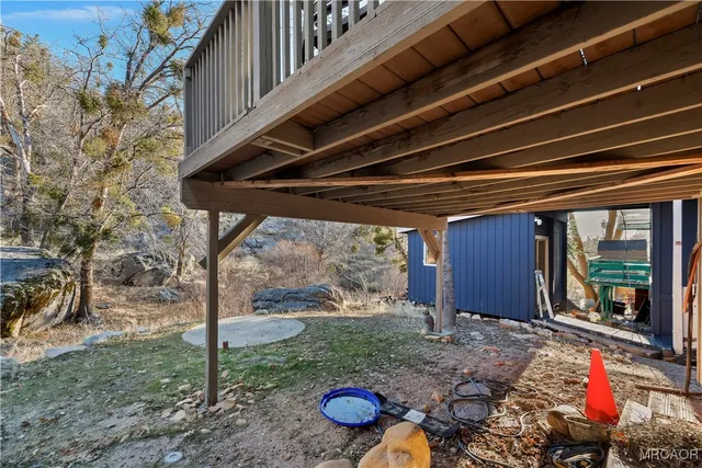 a backyard of a house with barbeque oven table and chairs