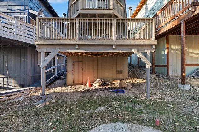 a backyard of a house with barbeque oven table and chairs