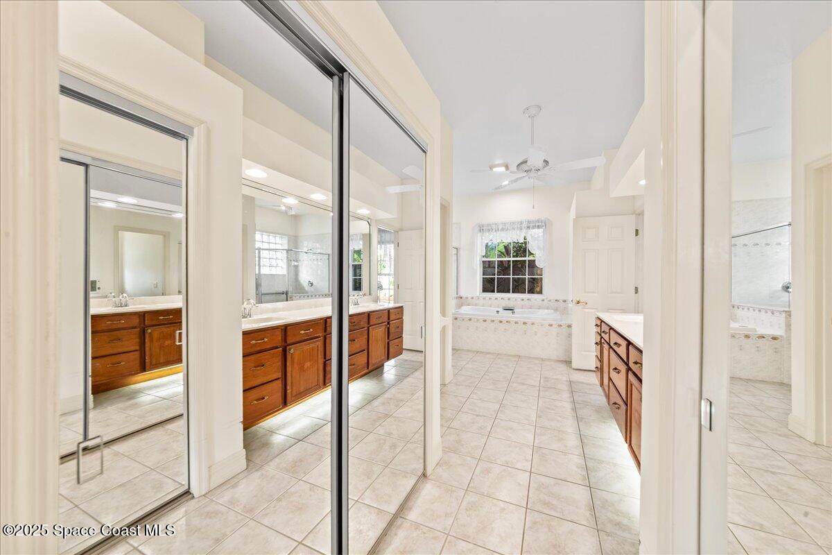 4245 Windover Way Melbourne, FL 32934 - Photo 15 of 50 a bathroom with a tub and shower