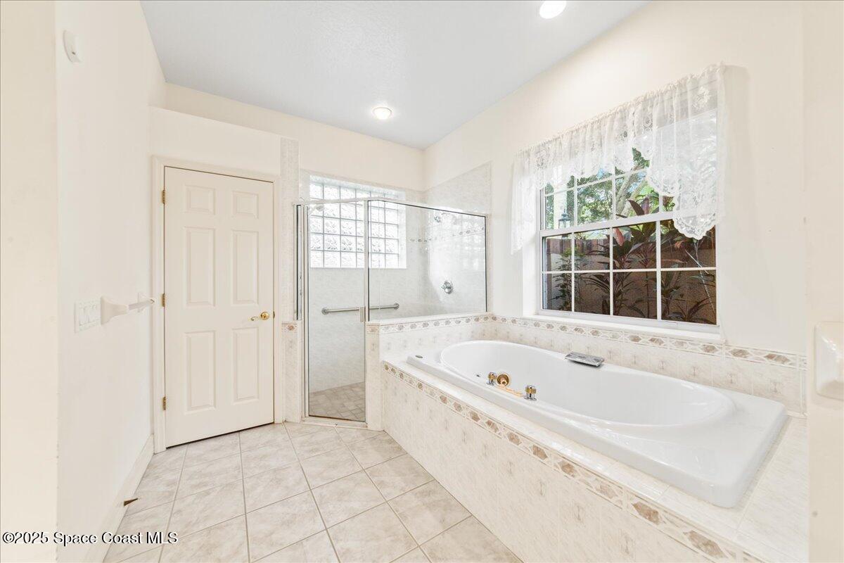 4245 Windover Way Melbourne, FL 32934 - Photo 17 of 50 a spacious bathroom with a tub and a window