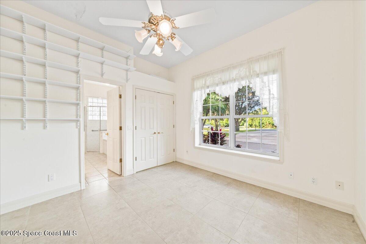 4245 Windover Way Melbourne, FL 32934 - Photo 19 of 50 an empty room with windows and entrance