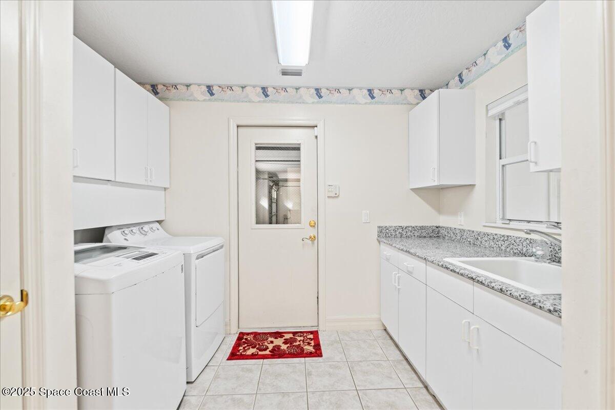 4245 Windover Way Melbourne, FL 32934 - Photo 23 of 50 a utility room with a sink washer and dryer