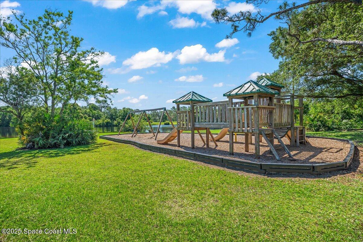 4245 Windover Way Melbourne, FL 32934 - Photo 39 of 50 a view of a house with swimming pool and a yard