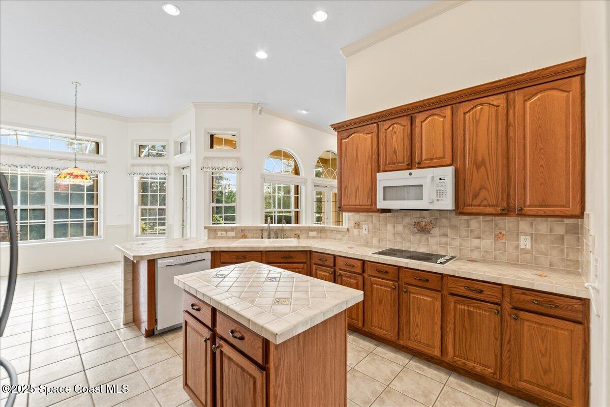 4245 Windover Way Melbourne, FL 32934 - Photo 8 of 50 a kitchen with a stove a sink and a refrigerator