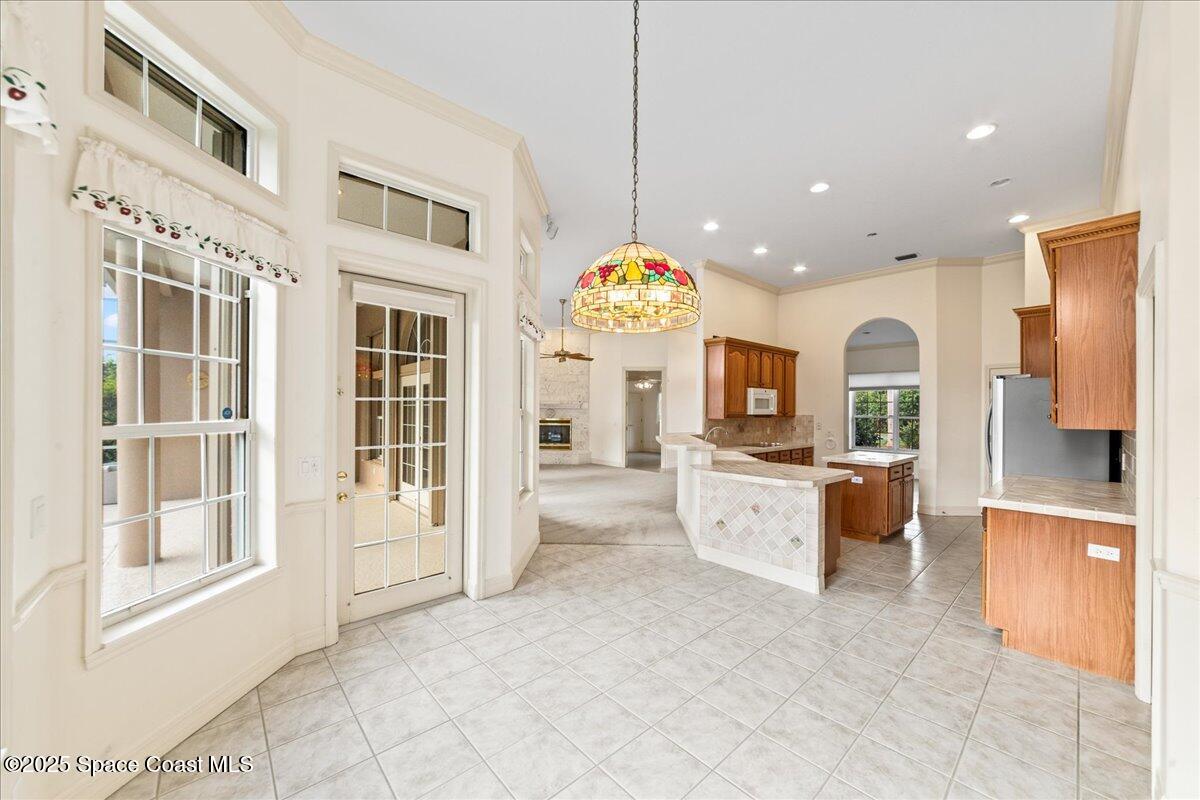 4245 Windover Way Melbourne, FL 32934 - Photo 10 of 50 a large white kitchen with a large window and stainless steel appliances