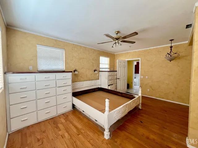 a room with pool table and ceiling fan