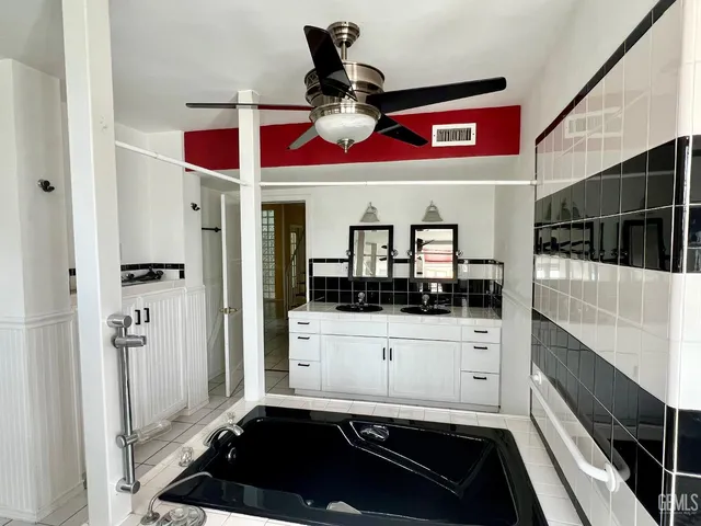 a kitchen with stainless steel appliances kitchen island granite countertop a refrigerator and a stove