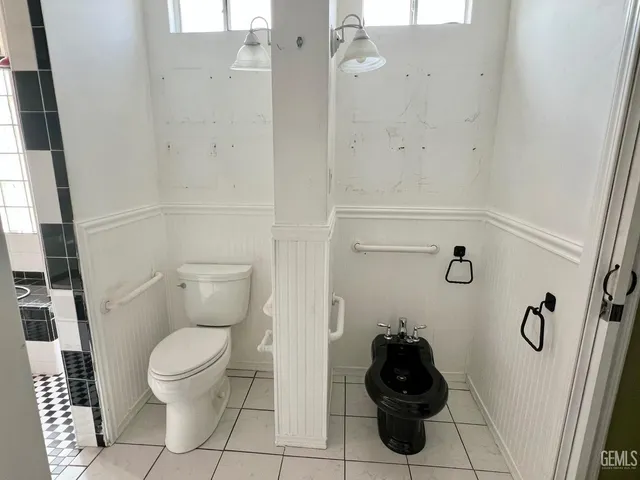 a bathroom with a toilet and a shower curtain
