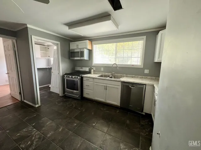 a kitchen with a sink stove and refrigerator
