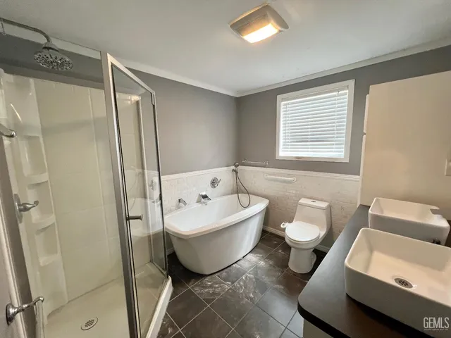 a bathroom with a toilet sink and shower