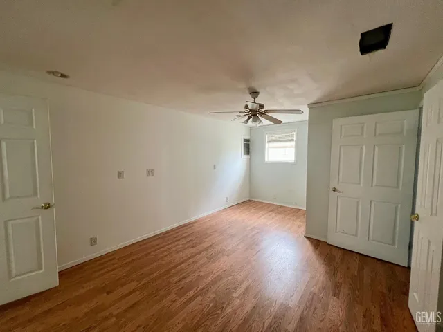 a view of an empty room and wooden floor