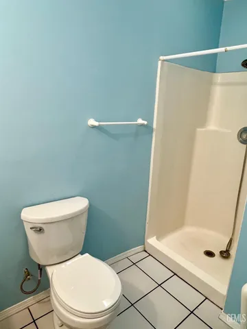 a white toilet sitting next to a bathroom sink and tub