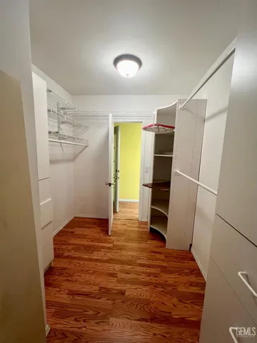 a view of walk in closet with empty racks