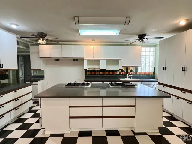 a kitchen with a sink a stove and a refrigerator