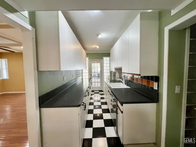a kitchen with a refrigerator and cabinets