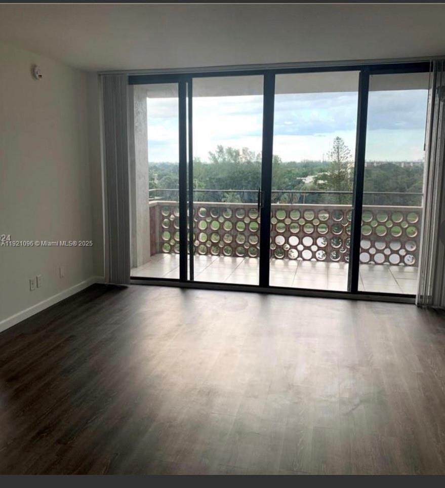 4222 Inverrary Boulevard, Unit 4814 Lauderhill, FL 33319 - Photo 2 of 4 wooden floor in an empty room with a window