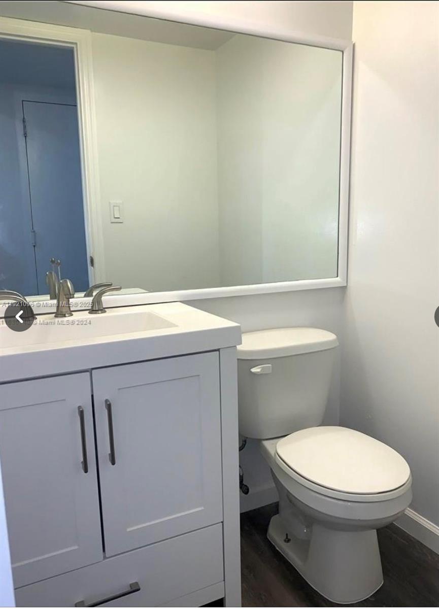 4222 Inverrary Boulevard, Unit 4814 Lauderhill, FL 33319 - Photo 4 of 4 a bathroom with a sink a toilet and mirror