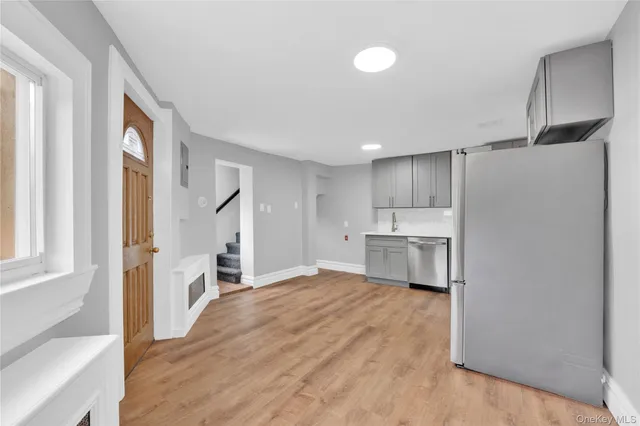 a kitchen with white cabinets and stainless steel appliances