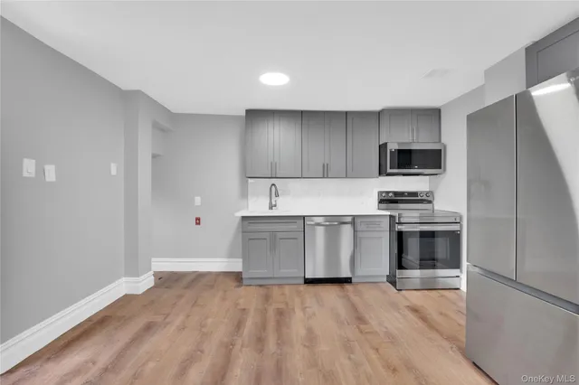 a kitchen with a refrigerator stove and microwave