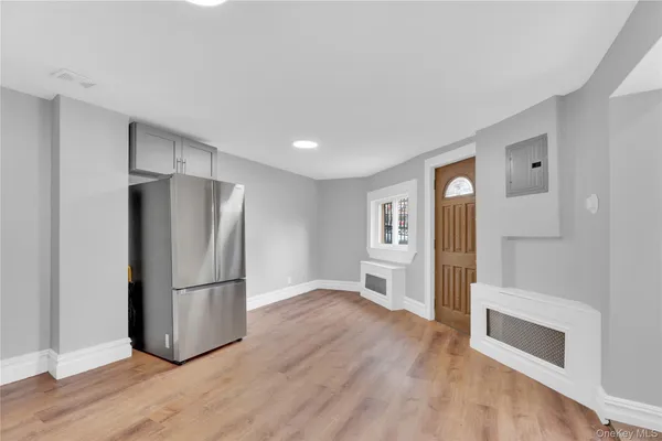 a kitchen with a refrigerator and a stove top oven
