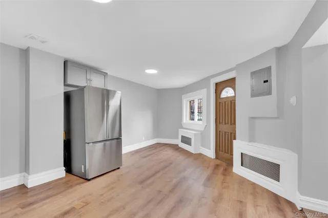 a kitchen with a refrigerator and a stove top oven