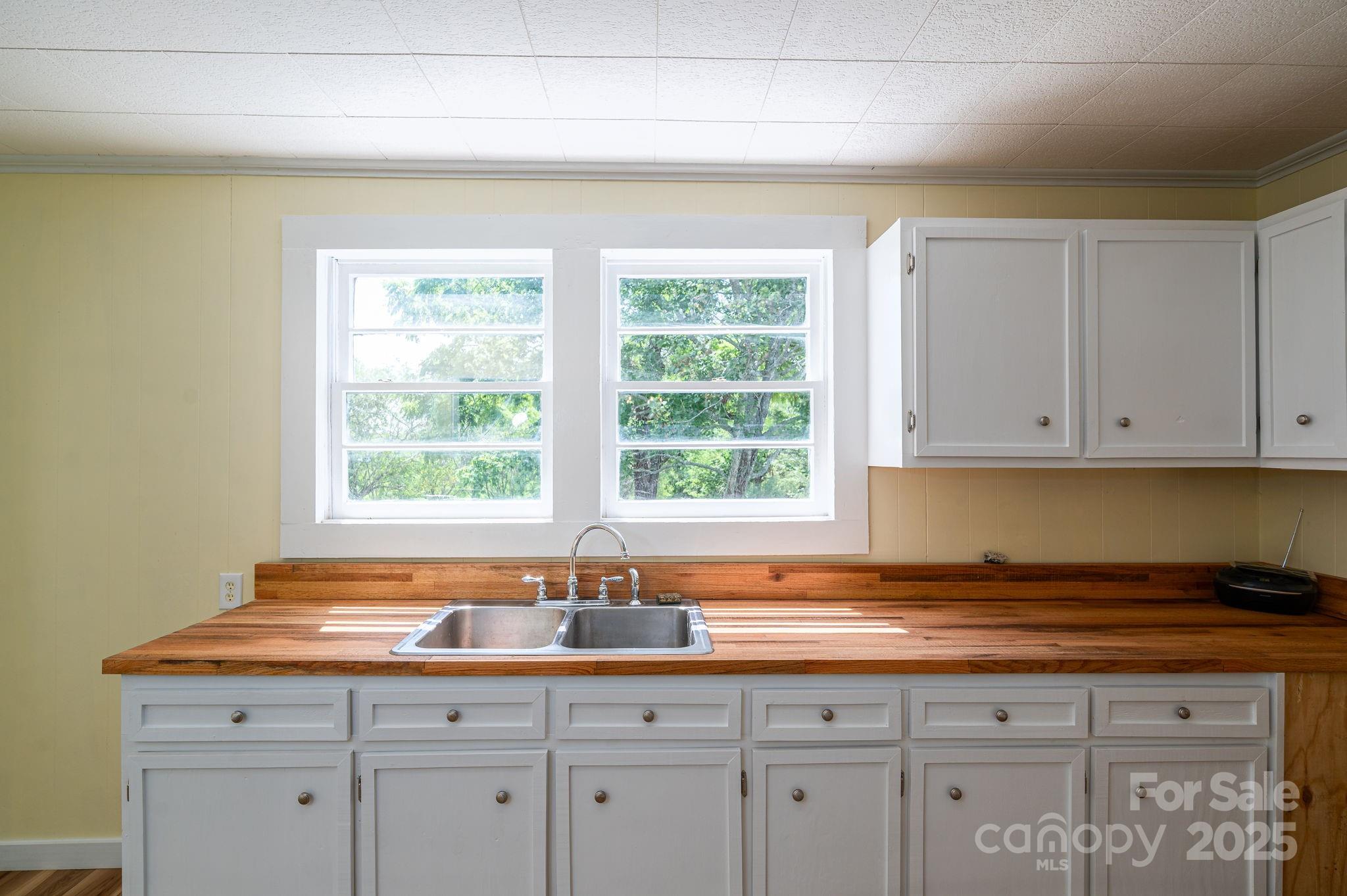5746 Casar Road Casar, NC 28020 - Photo 11 of 24 a kitchen with granite countertop white cabinets and a window