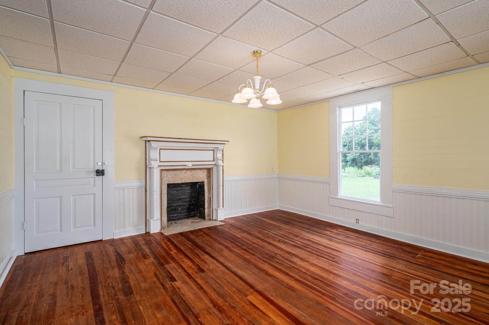 5746 Casar Road Casar, NC 28020 - Photo 14 of 24 a view of an empty room with a fireplace and a window