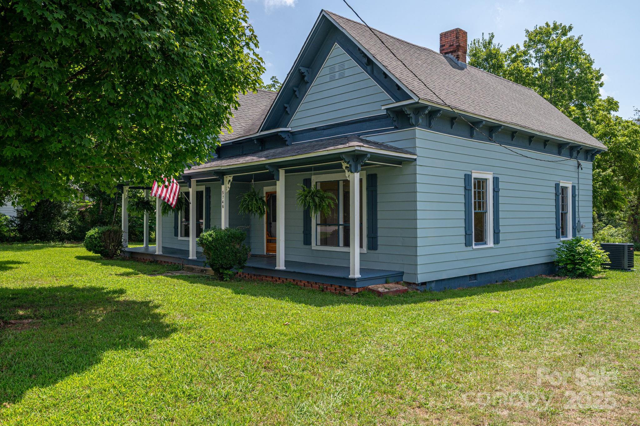5746 Casar Road Casar, NC 28020 - Photo 2 of 24 a view of a house with a yard plants and large tree