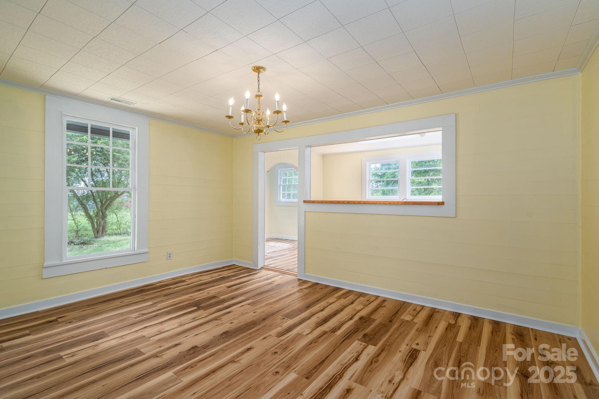 5746 Casar Road Casar, NC 28020 - Photo 8 of 24 a view of empty room with wooden floor and fan
