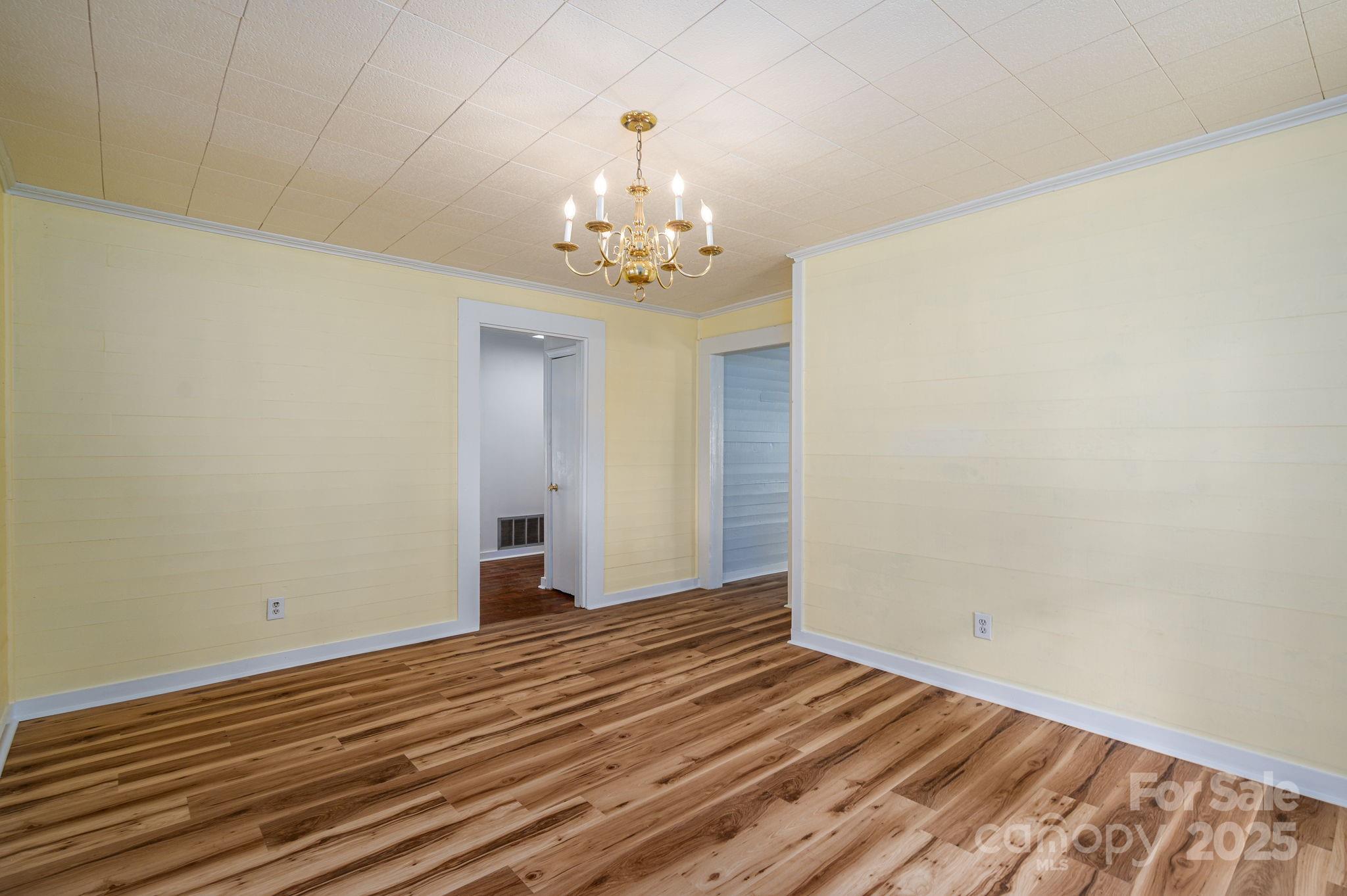 5746 Casar Road Casar, NC 28020 - Photo 9 of 24 wooden floor in an empty room with a chandelier