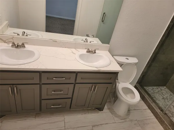 a bathroom with a sink toilet and mirror