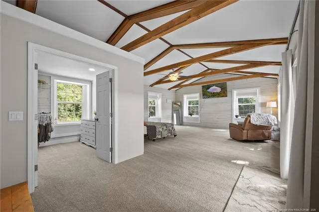 a view of a livingroom with furniture and a window
