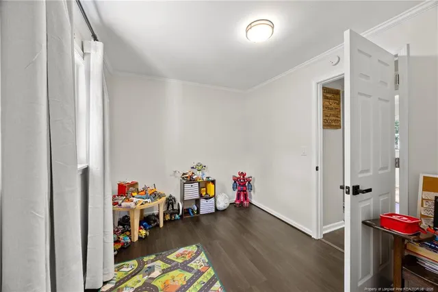a view of a room with toys and wooden floor