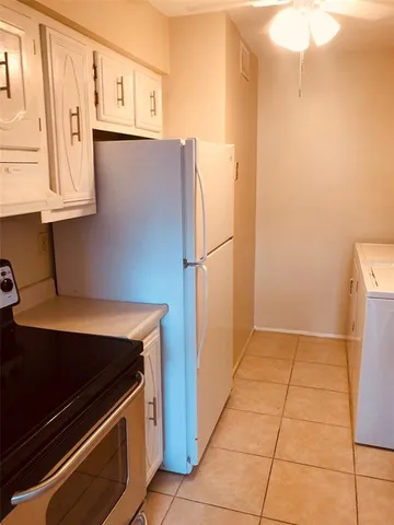 a kitchen with stainless steel appliances a refrigerator and cabinets