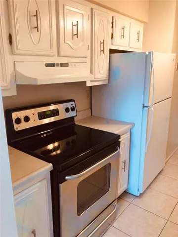 a stove top oven sitting inside of a kitchen