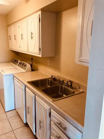a kitchen with a sink and cabinets